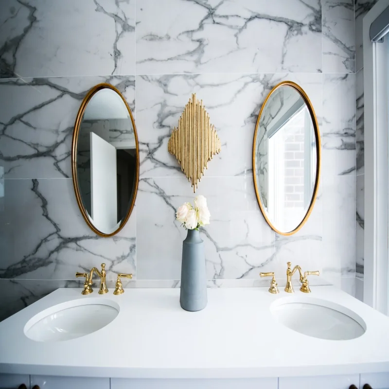 Dressing mirrors on the ceramic walls and a luxurious brass water faucets.